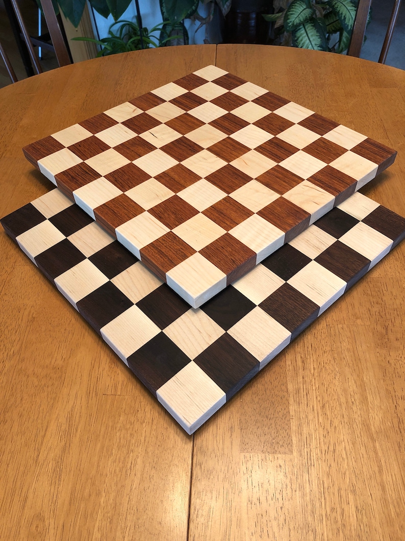 Top board is Jatoba Cherry with Hard Maple.  The reddish tones will darker over time.
The bottom board is Black Walnut and Hard Maple.  Tone intensity will vary.
