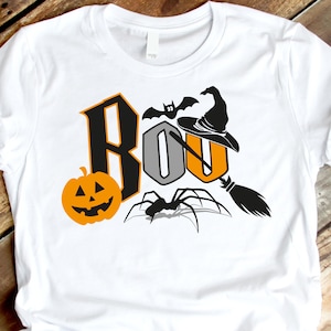 May include: White t-shirt with a black and orange graphic design that says "BOO" with a witch's hat, a spider, a bat, and a pumpkin.