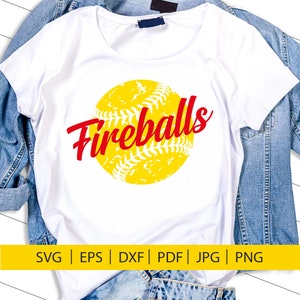 May include: A white t-shirt featuring a yellow softball with red stitching and the word "Fireballs" in red text.
