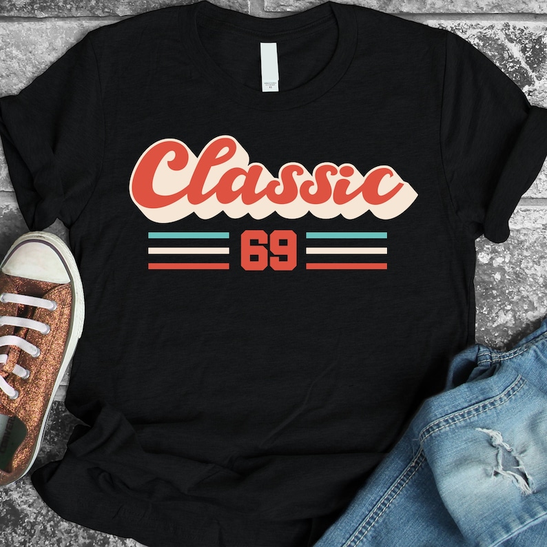 May include: Black t-shirt with a red, white, and blue retro-style graphic that says "Classic 69".