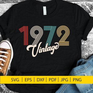 May include: A black t-shirt with a vintage 1972 design in red, yellow, blue, and green stripes. The text "Vintage" is written in a stylized font below the year.