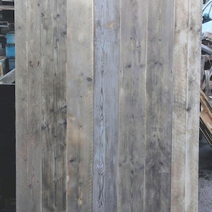 May include: A weathered wood panel made of reclaimed wood planks. The wood is a mix of light and dark brown with a grey patina. The panel is approximately 1.2 metres wide and 1.8 metres tall.