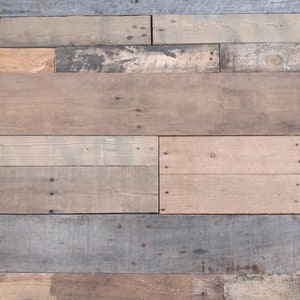 May include: A close-up of a wall made of reclaimed wood planks. The wood is a mix of light and dark brown, grey, and beige. The planks are arranged horizontally and have a rustic, weathered look.