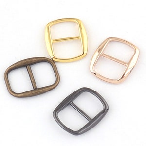 Puede incluir: Cuatro hebillas deslizantes de metal en diferentes acabados: oro, oro rosa, latón antiguo y negro.
