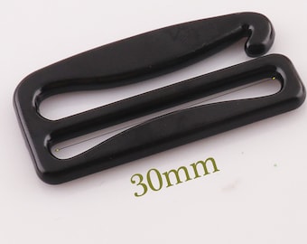 May include: Black plastic bra strap slider measuring 30mm in length.