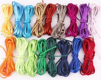 May include: Assortment of 15 spools of colorful waxed cotton cord. The cords are arranged in rows of three, with each row featuring a different color combination. The colors include orange, light green, green, blue, navy blue, red, purple, pink, brown, beige, and yellow.