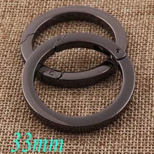 May include: Two black metal key rings with a swivel clasp. The rings are 33mm in diameter.