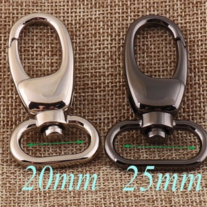 Op de afbeelding: Twee metalen draaibare sluitingen, een zilveren en een zwarte, met een opening van respectievelijk 20 mm en 25 mm.