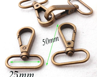 May include: Several antique bronze swivel snap hooks. The hooks are 50mm long and 25mm wide. The hardware has a spring-loaded clasp and a rotating eyelet for attaching to straps or other items.