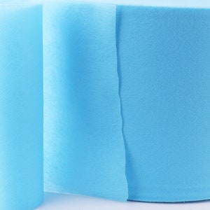 May include: A roll of light blue non-woven fabric. The fabric is soft and smooth, and it is perfect for a variety of crafts and projects.