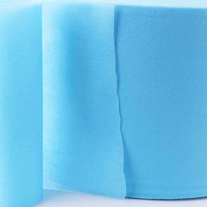 May include: A roll of light blue non-woven fabric. The fabric is soft and smooth, and it is perfect for a variety of crafts and projects.