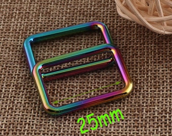 May include: Two rainbow-colored metal D-rings, each measuring 25mm in width. The rings are stacked on top of each other.