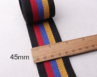 May include: Black and white striped webbing with red, blue, and yellow stripes. The webbing is 45mm wide and is measured with a ruler.