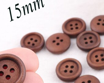May include: A close-up of ten brown wooden buttons, each with four holes. The buttons are 15mm in diameter.