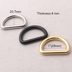 May include: Three D-rings in different finishes: silver, black, and gold. The rings are 1 inch (25 mm) in diameter and 4 mm thick.