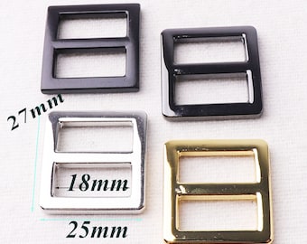 May include: Four metal slider buckles in black, silver, and gold. The buckles are 27 mm wide, 25 mm tall, and have an 18 mm opening.