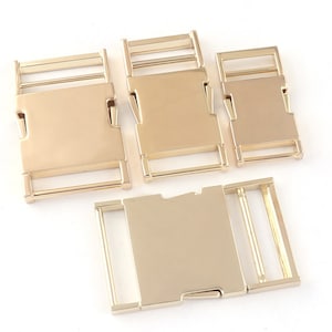May include: Four gold-colored metal buckles of different sizes. The buckles are designed for use with straps or belts.