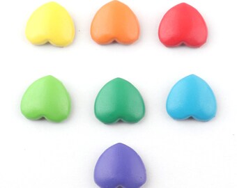 May include: Seven heart-shaped wooden beads in rainbow colors: yellow, orange, red, green, teal, blue, and purple.