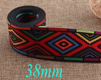 May include: A roll of colorful woven trim with a geometric pattern in shades of red, blue, green, yellow, and black. The trim is 38mm wide.