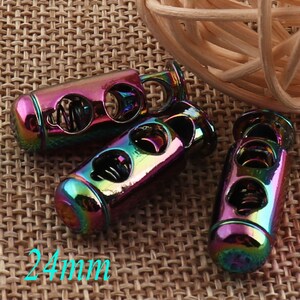 May include: Several iridescent metal cord locks with a rainbow finish. Each cord lock has three holes and a spring mechanism inside. The cord locks are approximately 24mm in length.