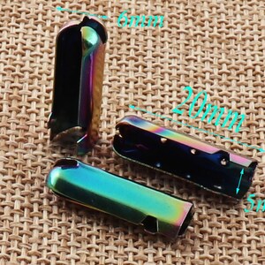 May include: Three iridescent metal cord ends, each approximately 0.8 inches long, 0.2 inches wide, and 0.2 inches high. The cord ends have a rainbow finish, with a mix of blue, green, and purple hues. They are designed to crimp onto the end of a cord.