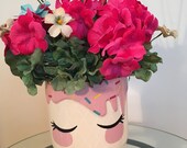 Girl 39 s face in colorful ceramic vase, bright pink floral arrangement, unique decorative container, blue bow in hair