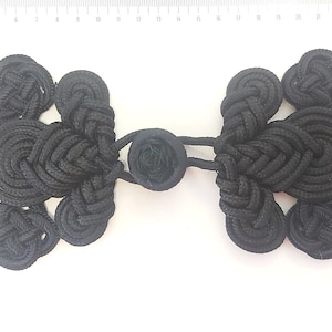 Large toggle in black trimmings. Big toggle button closures