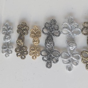 May include: A set of ten decorative Chinese knot toggles in various metallic finishes, including silver, gold, and black.