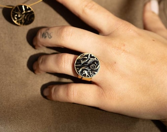 Gold-plated ring with black, wavy plates. Handmade jewelry