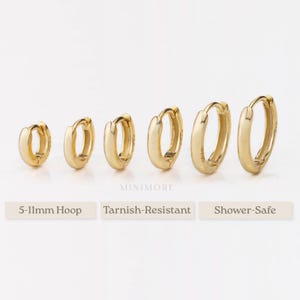 Peut inclure: Six boucles d'oreilles créoles dorées de différentes tailles sont présentées sur fond blanc. Les boucles d'oreilles mesurent entre 5 et 11 mm. Le texte en dessous indique "MINIMORE", "5-11mm Hoop", "Tarnish-Resistant" et "Shower-Safe".
