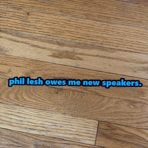 Phil Lesh Owes Me New Speakers Sticker - Black and Carolina Blue - Grateful Dead,  Phil Lesh, Bass Player