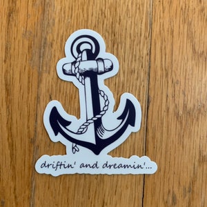 May include: A white sticker with a black anchor and the text "driftin' and dreamin'...".