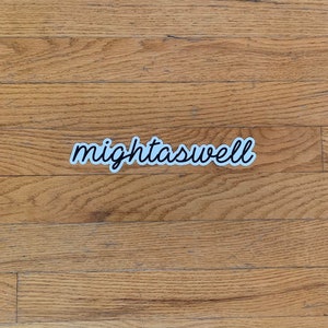May include: A white sticker with black lettering that reads "mightaswell" on a wood floor.