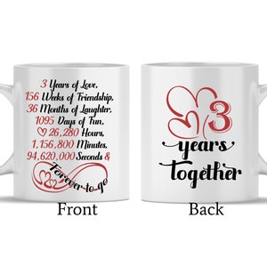 May include: White ceramic mug with a black and red design. The front of the mug reads "3 Years of Love, 156 Weeks of Friendship, 36 Months of Laughter, 1095 Days of Fun, 26,280 Hours, 1,156,800 Minutes, 94,620,000 Seconds & Forever to go". The back of the mug reads "3 years together".