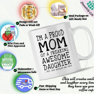 May include: White ceramic coffee mug with black text that reads "I'm a proud mom of a freaking awesome daughter...yes, she bought me this".