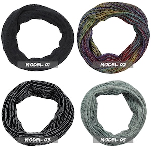May include: Four different styles of knitted neck warmers. The first is black, the second is multicoloured, the third is black with white stripes, and the fourth is green. Each warmer is labelled with a model number.