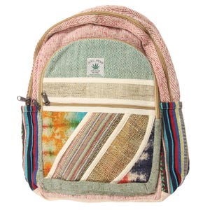 May include: A multi-colored hemp backpack with a large front pocket and a smaller pocket on the side. The backpack is made of a variety of fabrics, including hemp, cotton, and recycled materials. The backpack has a green leaf logo with the text "N.Y.C. HEMP" on it.