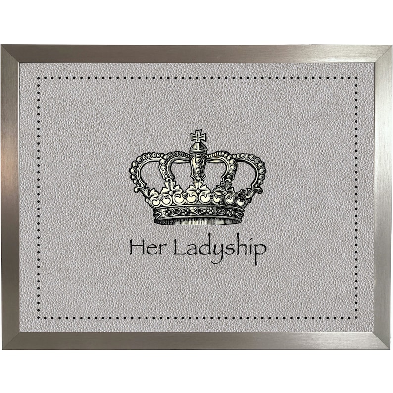 May include: A framed print with a silver frame and a gray background. The print features a black and white illustration of a crown with the text "Her Ladyship" underneath.