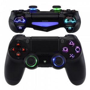 May include: Two black game controllers with illuminated buttons and joysticks. The top controller has blue and green lights, while the bottom controller has red, green, and purple lights. The controllers have the brand name "SONY" printed on them.