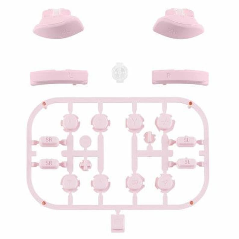 Puede incluir: Botones de repuesto de color rosa para un mando de juego. Los botones est&aacute;n dispuestos en una cuadr&iacute;cula con etiquetas para SR, SL, Y y otras funciones.
