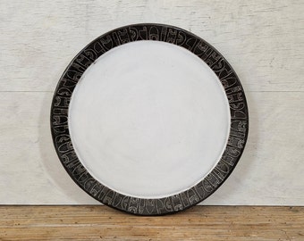 Round decorative serving platter with carved geometric shapes, stoneware pottery, black clay, durable quality ceramics