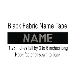 May include: Black fabric name tape with the word "NAME" in white lettering. The tape is 1.25 inches tall by 3 to 6 inches long and has a hook fastener sewn to the back.