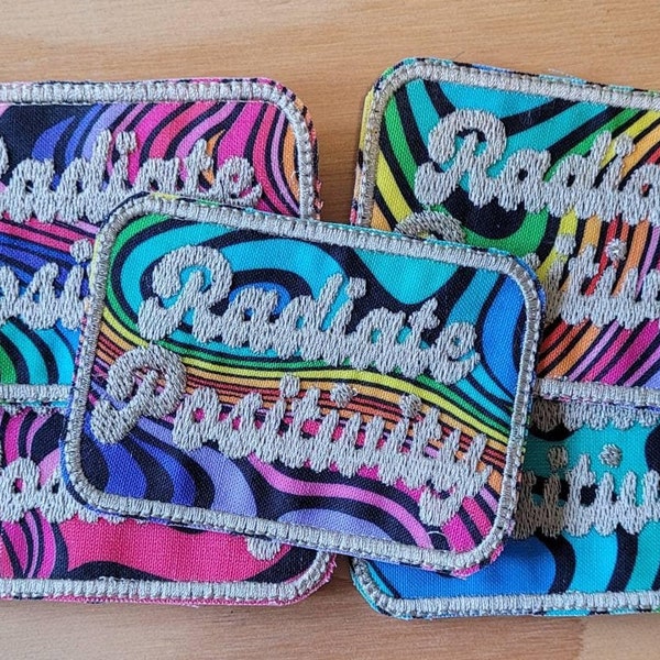 Radiate Positivity handmade sew on patch embroidered on colorful fabric