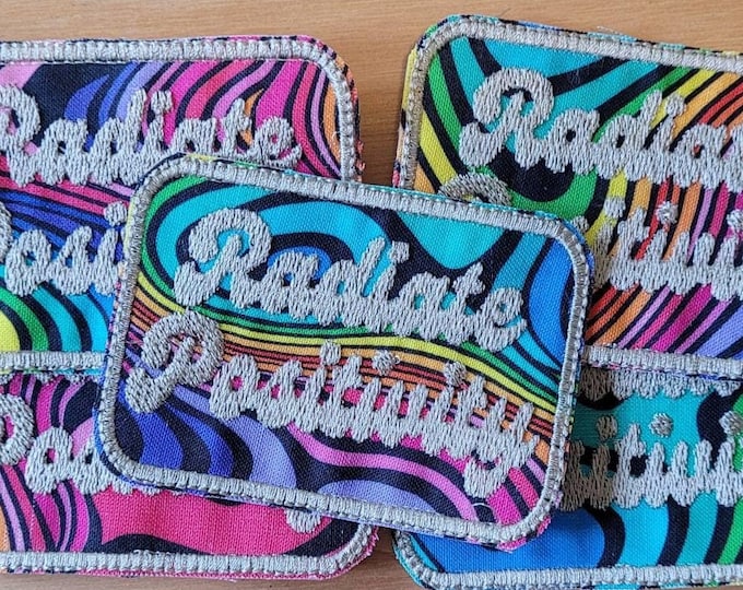 Radiate Positivity handmade sew on patch embroidered on colorful fabric