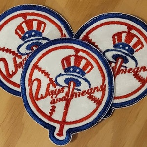 May include: Three white, blue and red embroidered patches with the words "Yankees" and a baseball bat and ball design.