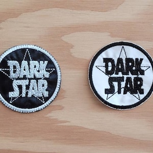 May include: Two round embroidered patches with a white star and the text "DARK STAR" in black. One patch is black with white text and the other is white with black text.