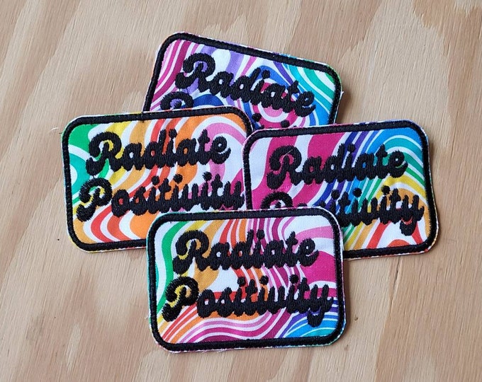 Radiate Positivity handmade sew on patch embroidered on colorful fabric