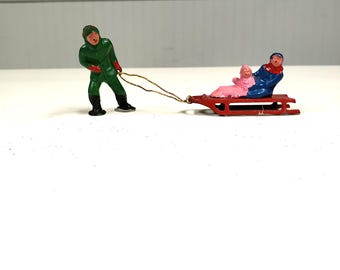 Vintage Train Toy: Man Pulling Sled with 2 Children Riders, All Metal From The 1950s - FREE SHIPPING!!