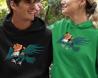 Gritty Riding an Eagle Funny Philadelphia Flyers Eagles Fan Gear Illustrated Cartoon Comic Style Hoodie Philly Unisex Hooded Sweatshirt