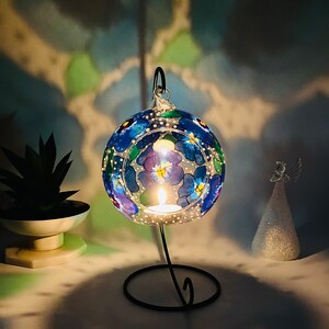 Hand Painted hanging glass candle holder with metal stand, with blue pansies and green leaves. Great choice as a unique gift for Mothers Day, Christmas Gift, Unique Birthday Gift, this glass tealight holder will truly impress the receiver.